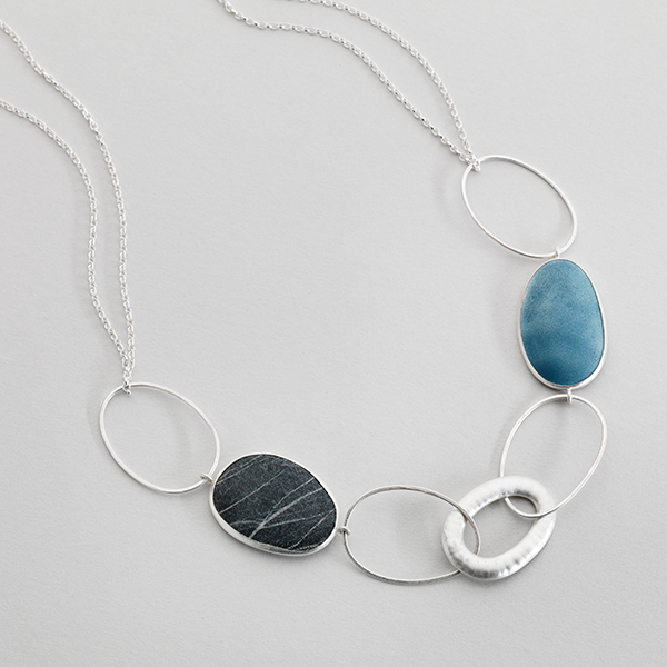 Silver necklace featuring loops, Iona stone and enammeled components.