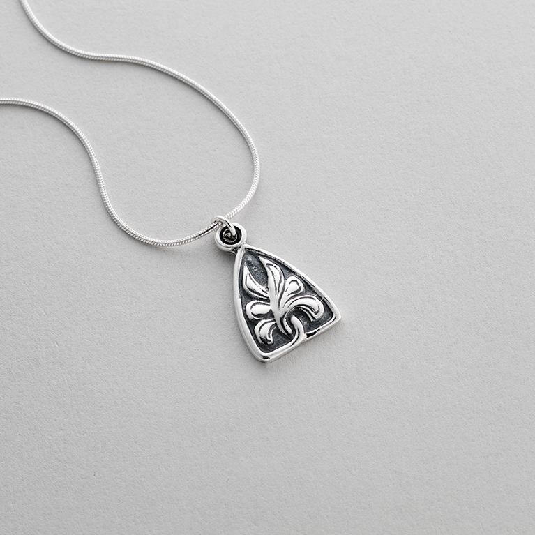 Silver pendant featuring a Celtic acanthus leaf design.