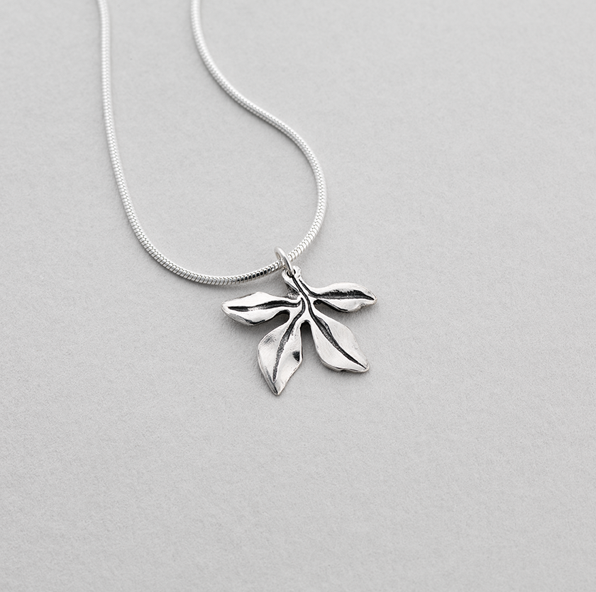 Silver pendant featuring a Celtic acanthus leaf design.