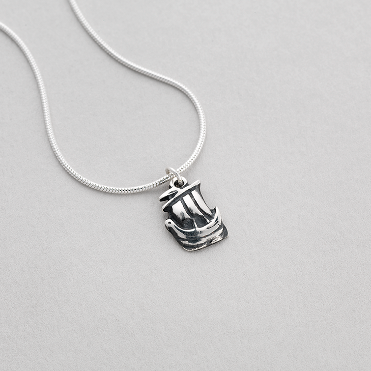 Silver pendant featuring a small Celtic galley design.